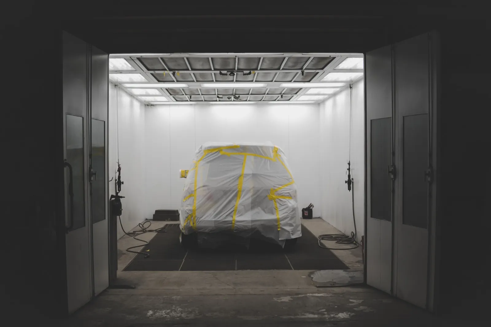 Vehicle masked for refinishing inside a commercial spray paint booth