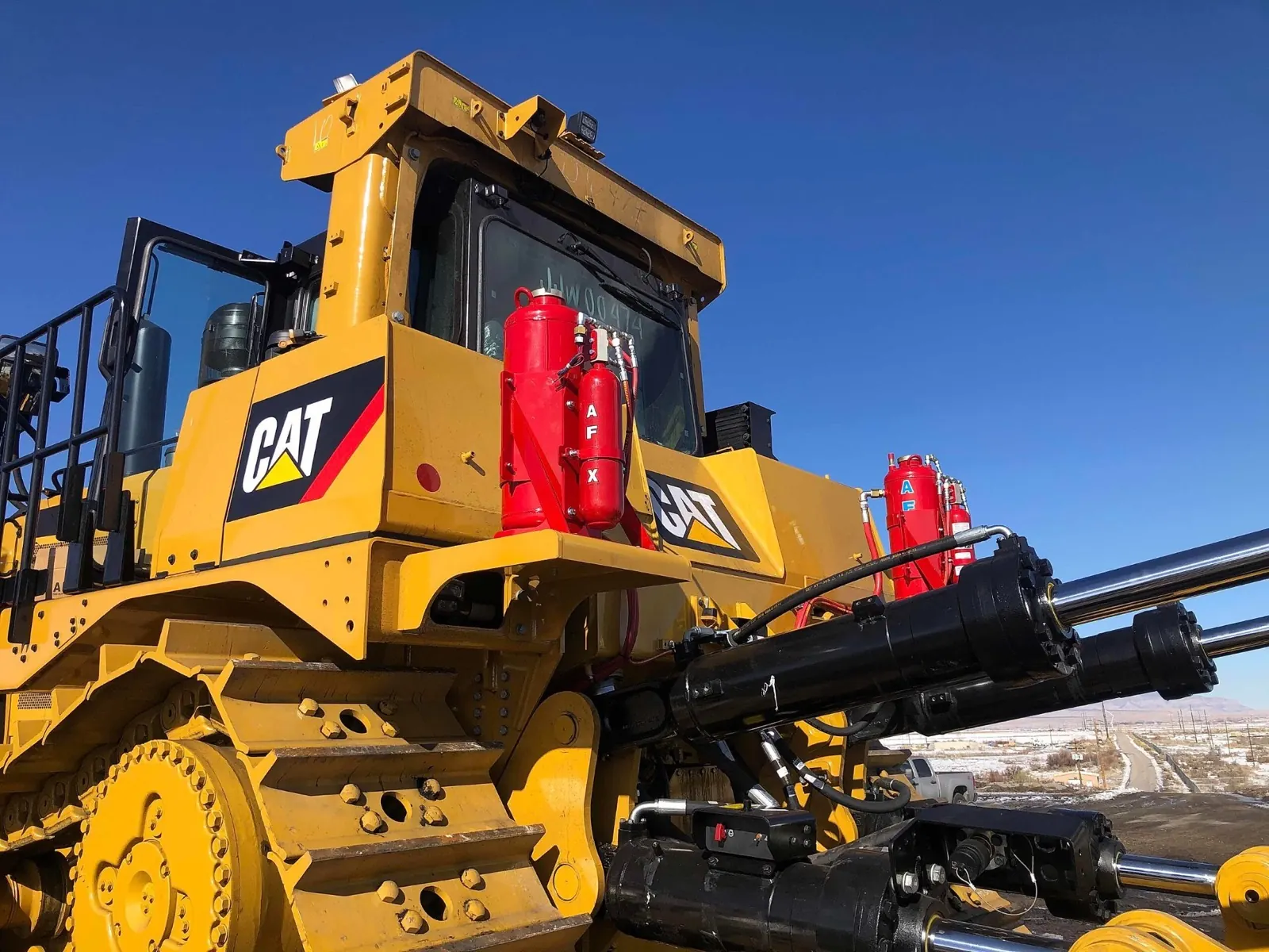 Caterpillar bulldozer equipped with AFX vehicle fire suppression cylinders